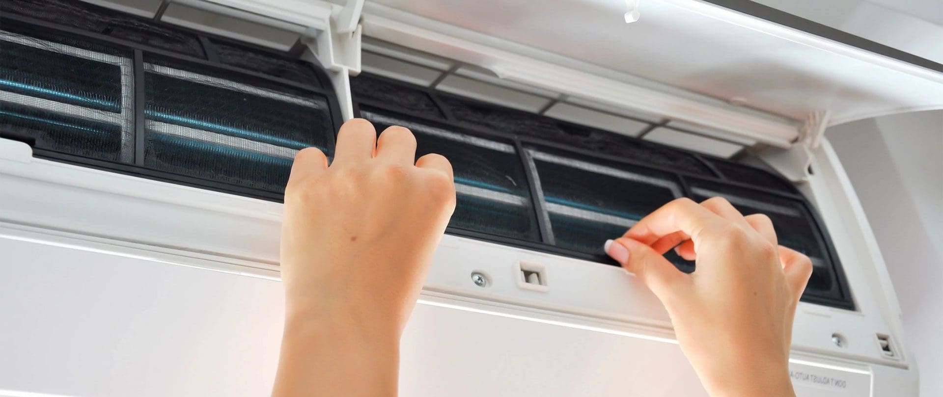 A person is using an air conditioner to clean it.