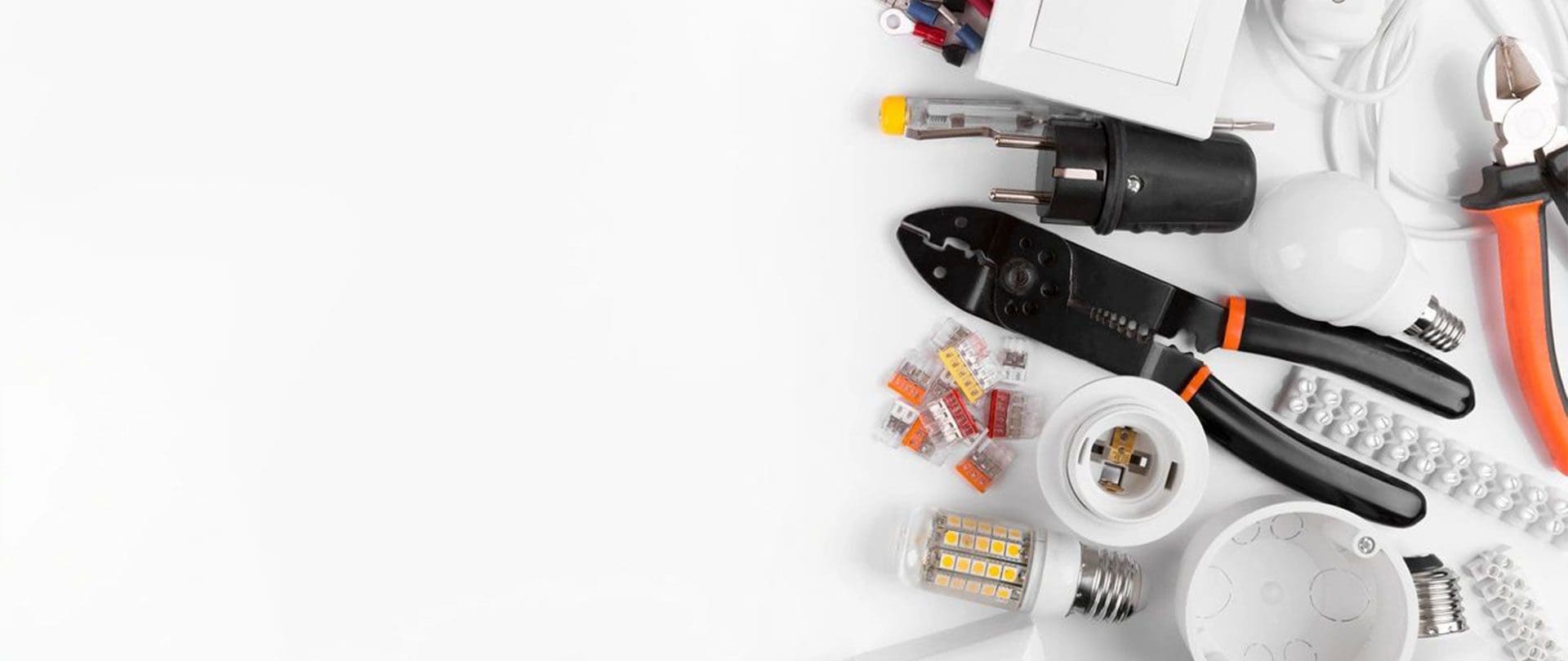 A white table topped with lots of electrical supplies.