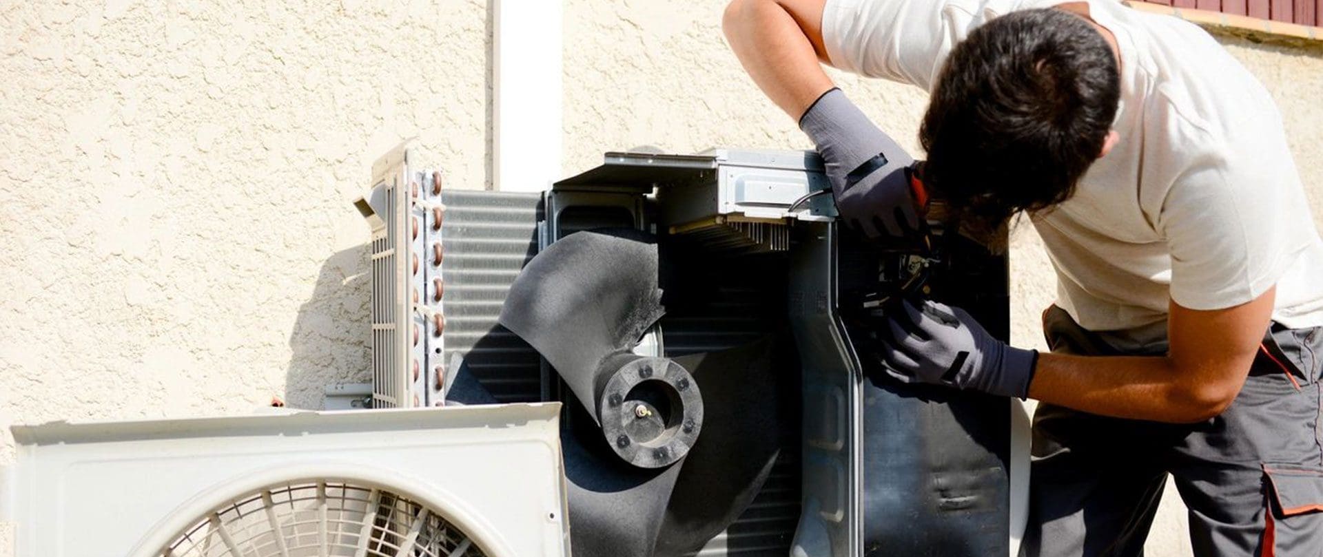 A person is working on an air conditioner.